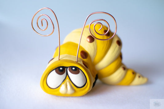 yellow small worm ceramic figurine