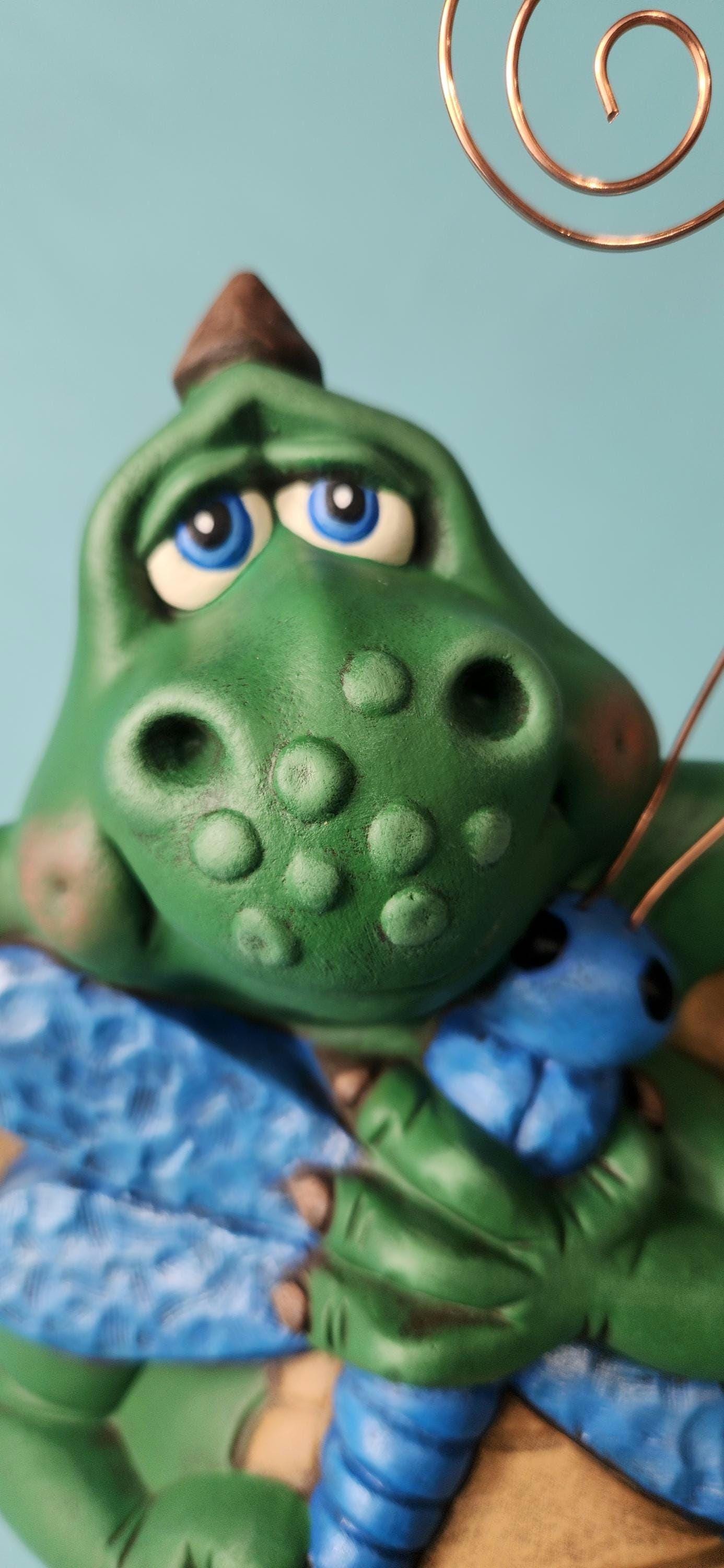 Silly Dragon holding a dragon fly