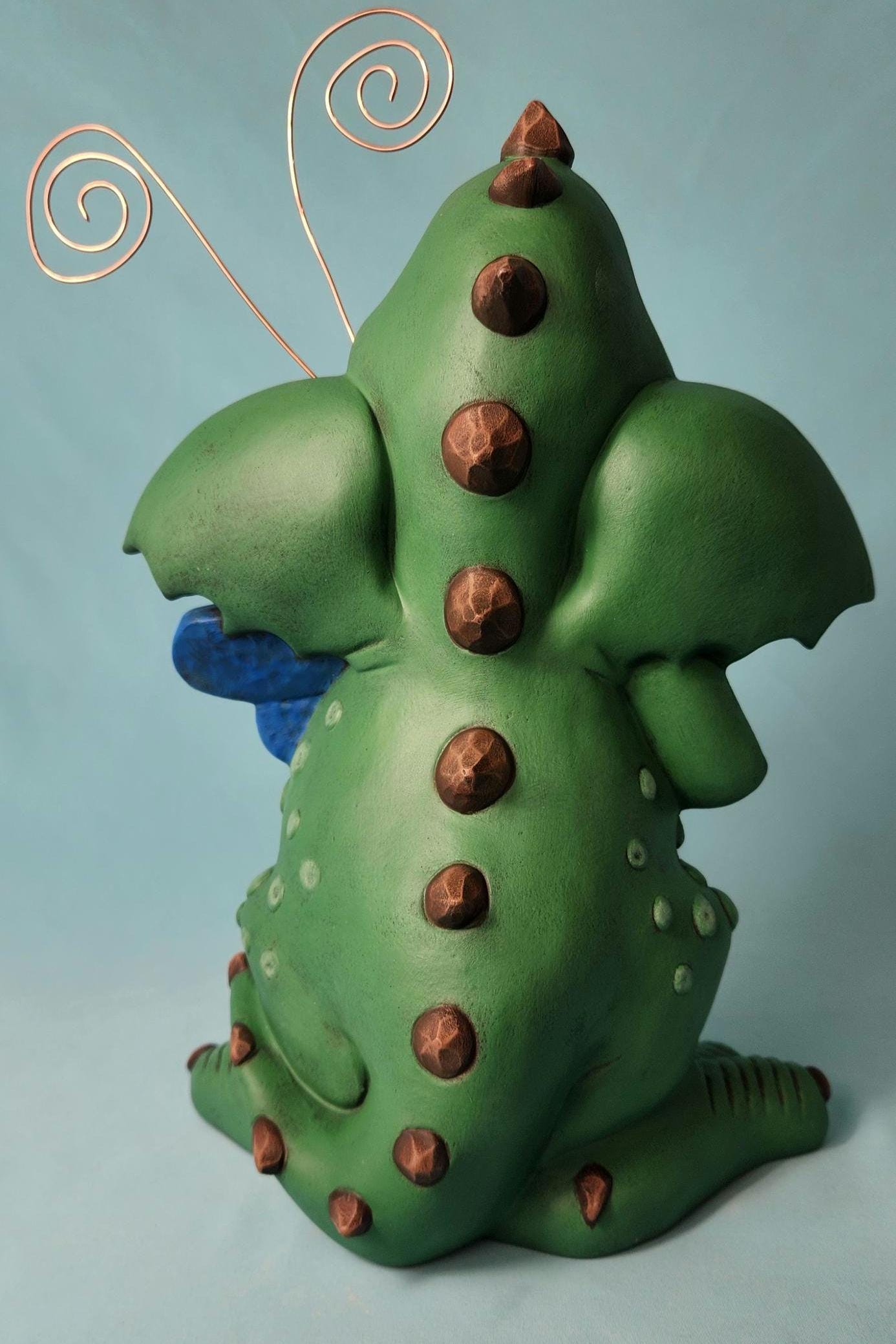 Silly Dragon holding a dragon fly