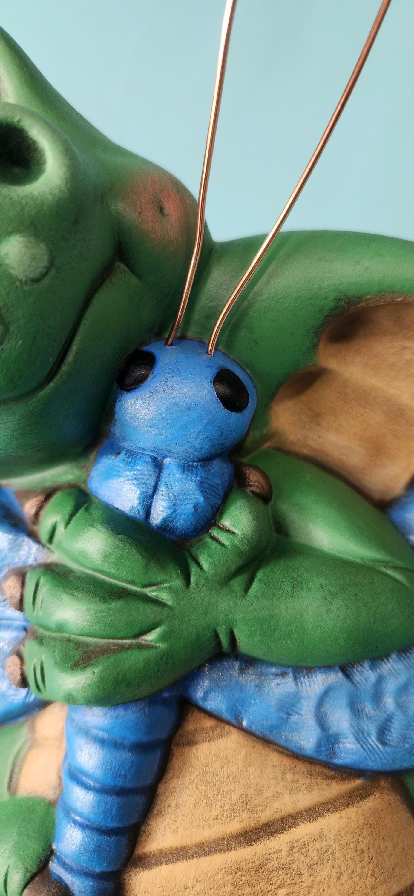 Silly Dragon holding a dragon fly