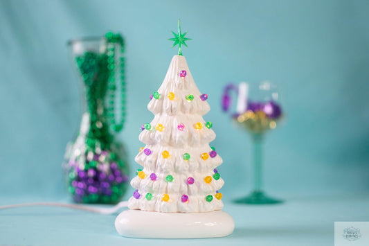 white christmas tree with mardi gras colored bulbs